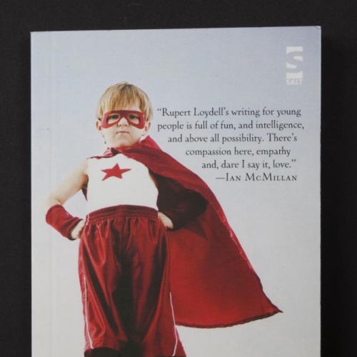 Book cover featuring little boy in red mask and cape hero outfit for The Fantasy Kid by senior lecturer, Rupert Loydell.