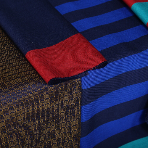 Hand woven fabric samples in dark blue and red colours.
