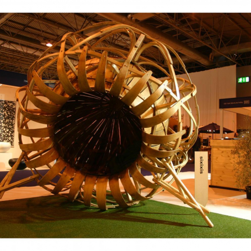 Large flower shaped sculpture made of curved wood.