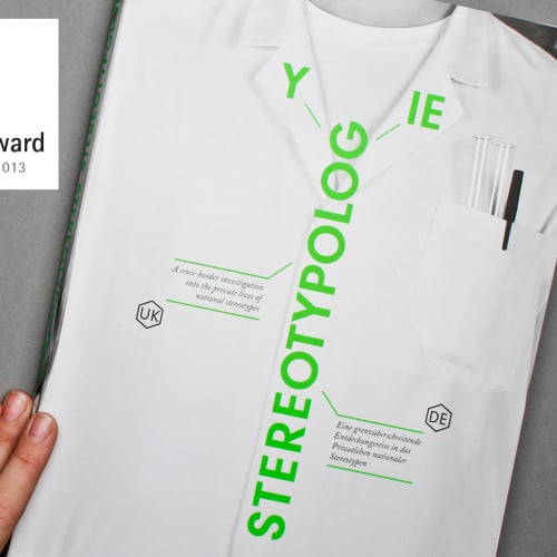 A journal cover of a white shirt and the bright green letters spelling Stereotypology.