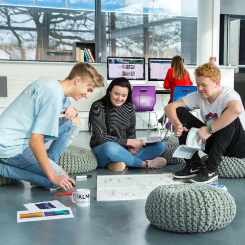 Falmouth University Business students sat on pebble cushions discussing ideas.