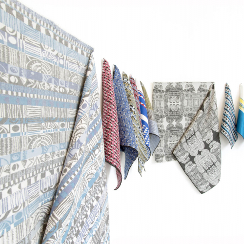 A display of different coloured jacquard woven fabrics.
