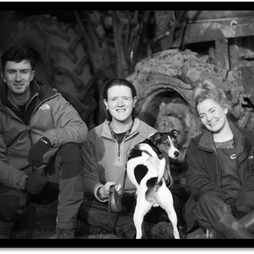 three people and a dog on film set