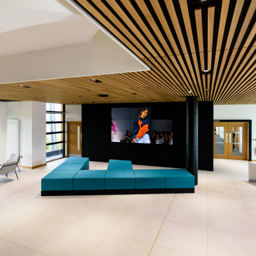 Creative Bridge Open plan event space with large screen minimalist design and seating at the Creative Bridge