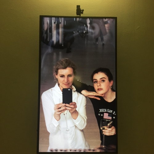 Two Falmouth University students taking a photo of themselves in a mirror