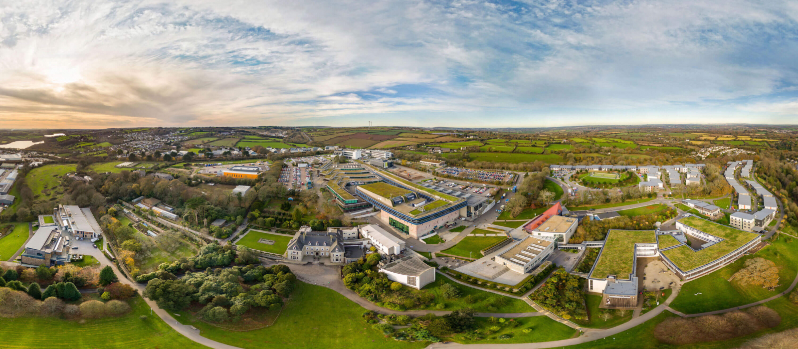 A wide angle aerial shot of Penryn campus with buildings and fields.