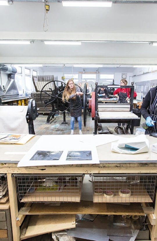 Students working in the printmaking studio on Falmouth University campus