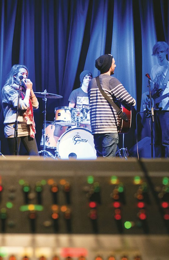 Band on a stage warming up with blue lighting